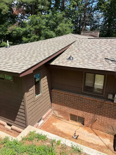 Cedar shake laundry room addition with shingles tied into the original roof in Cullowhee, North Carolina