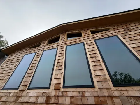 Cedar shake siding and tall windows with custom gable glass on a living room addition in Franklin, North Carolina