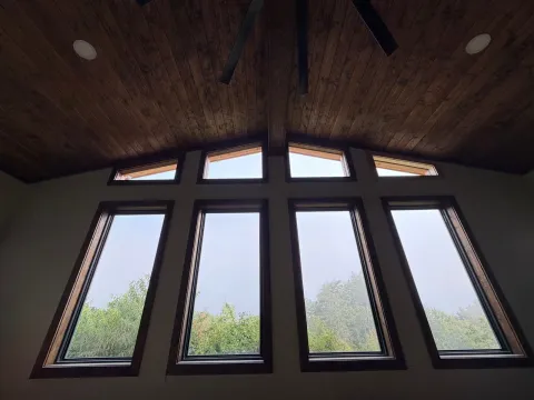 Wall of tall windows under a stained wood vaulted ceiling in a Franklin, North Carolina addition