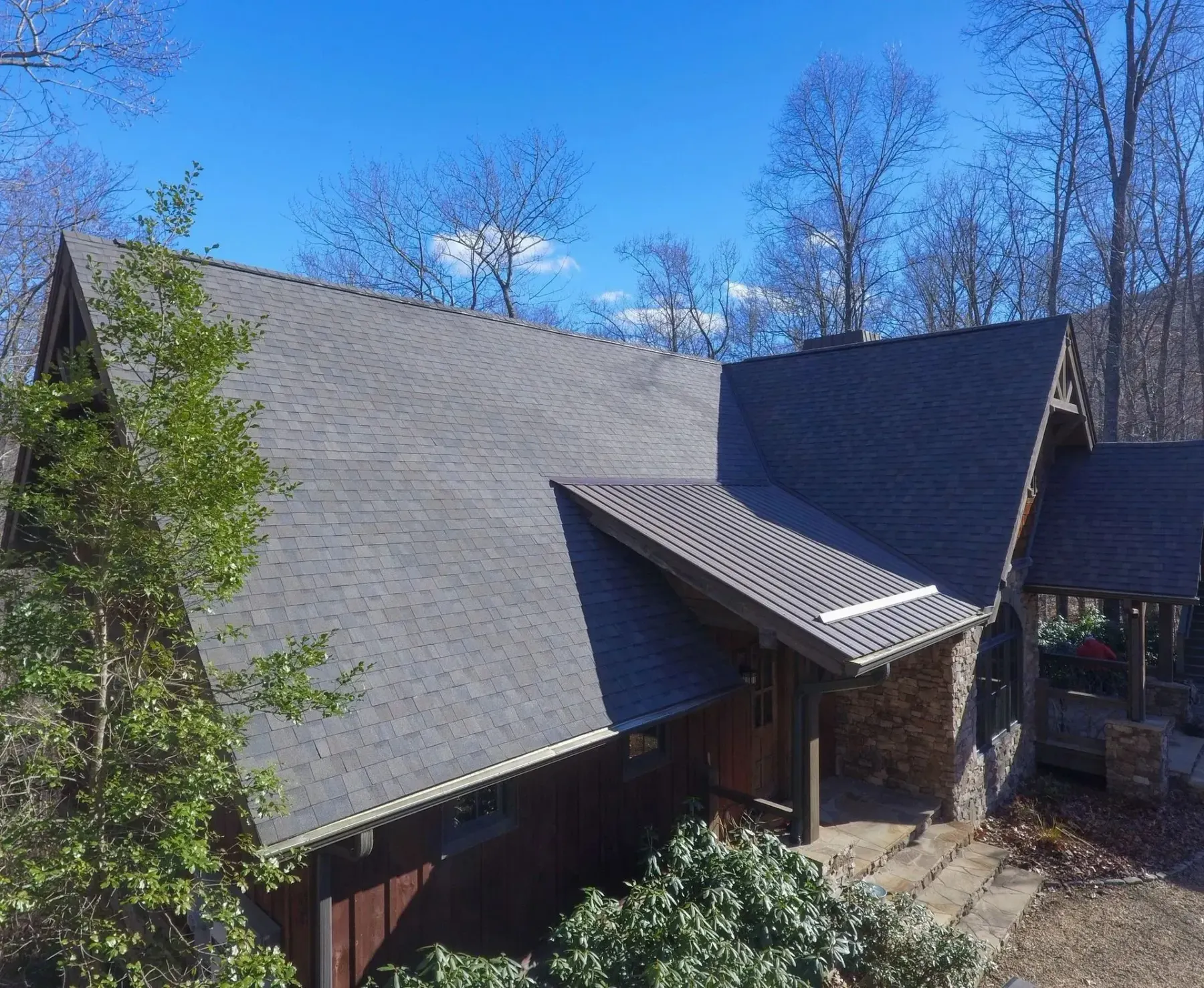 Mountain home with dimensional shingles and standing seam metal accents near Scaly Mountain, North Carolina