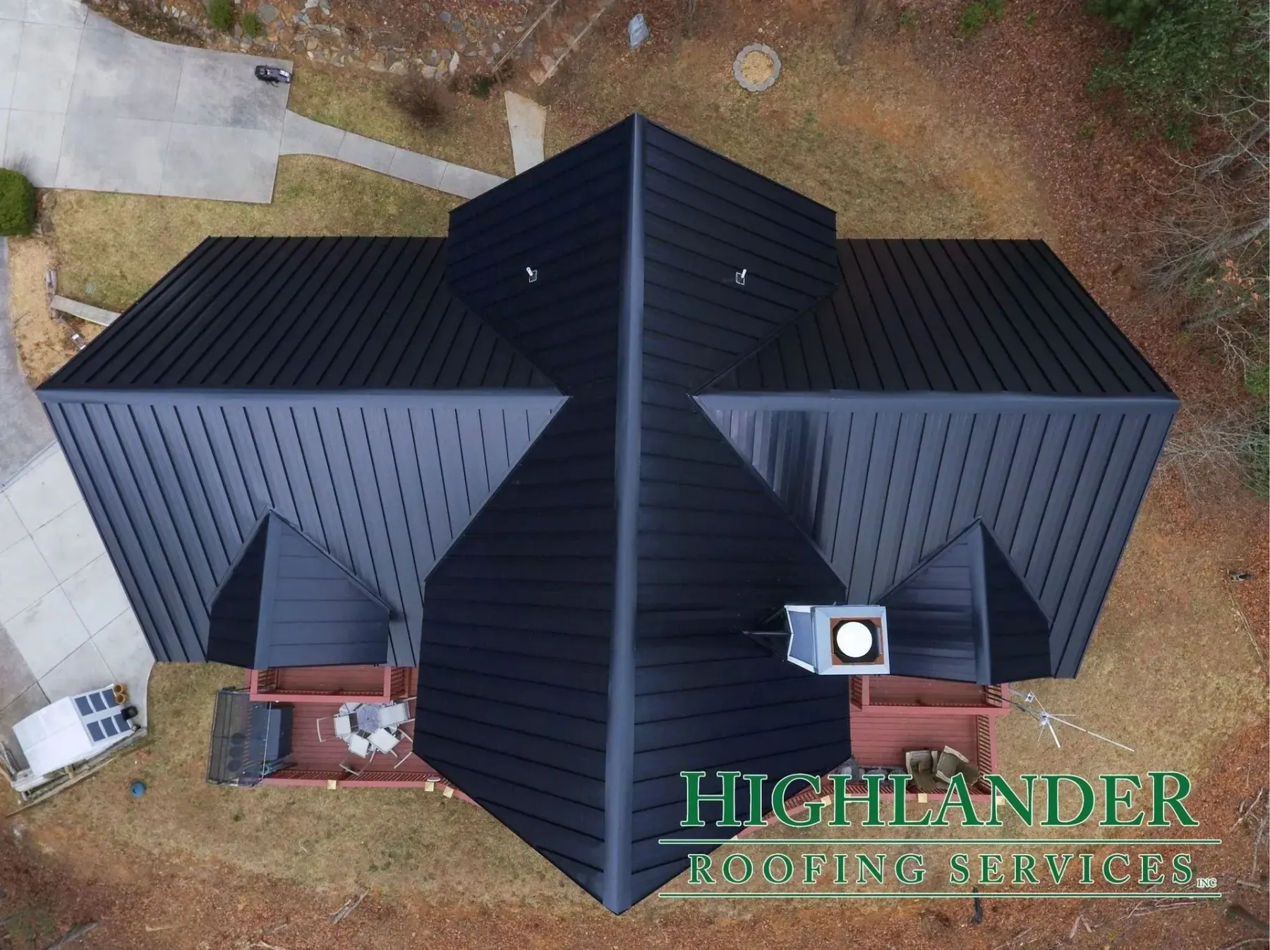 Dark bronze standing seam metal roof on a steep-pitch home in Highlands, North Carolina