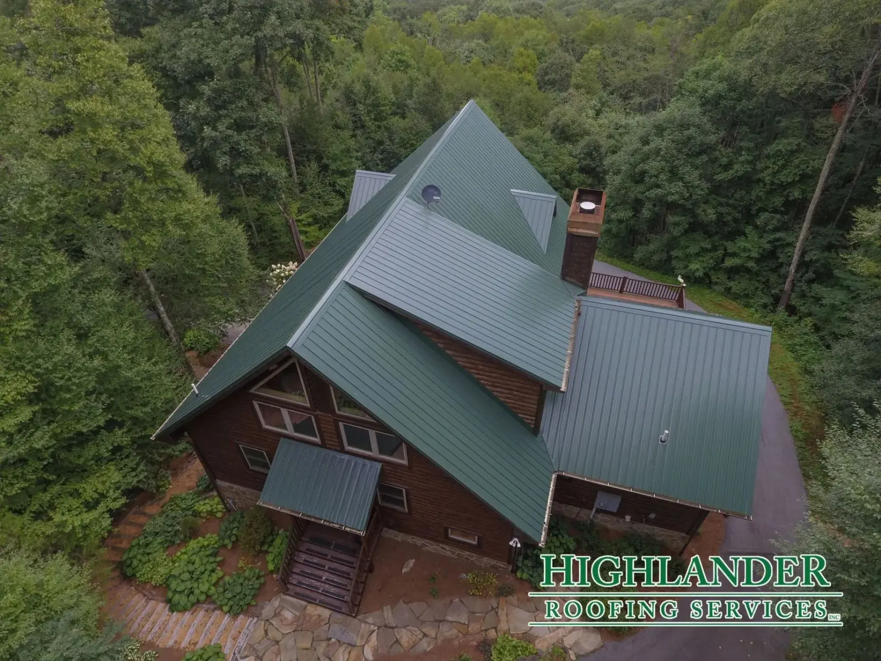 Green standing seam metal roof on a log cabin near Cashiers, North Carolina