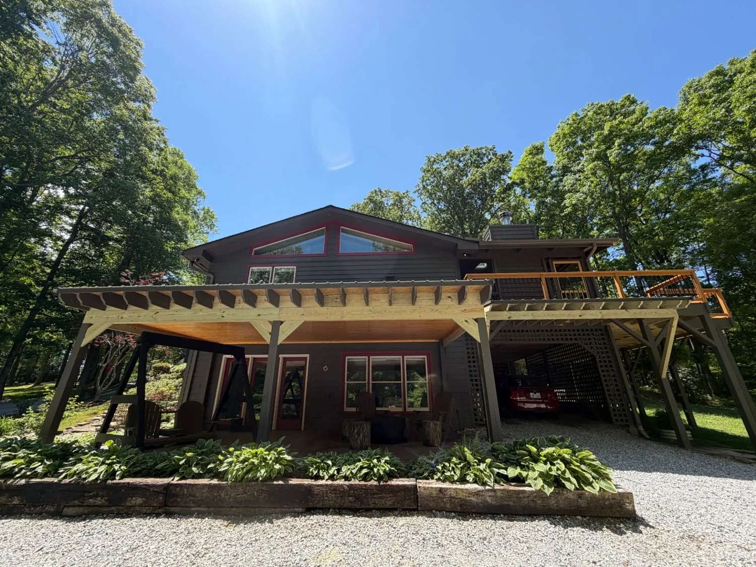 Open trellis converted to a covered patio with a metal roof and wood ceiling in Cashiers, North Carolina