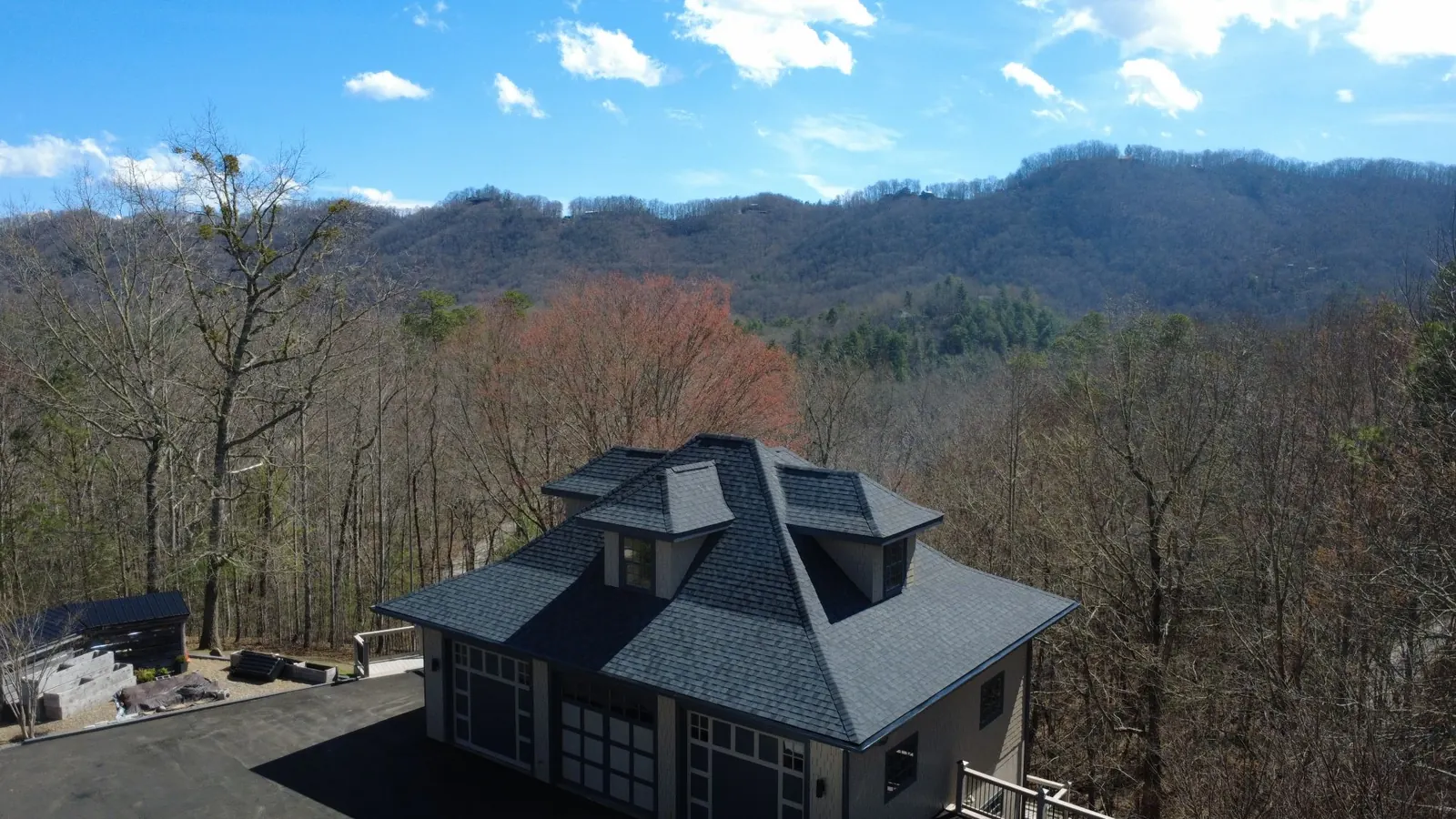 Charcoal dimensional shingle roof with dormers by Highlander Building Services, overlooking the Western North Carolina mountains