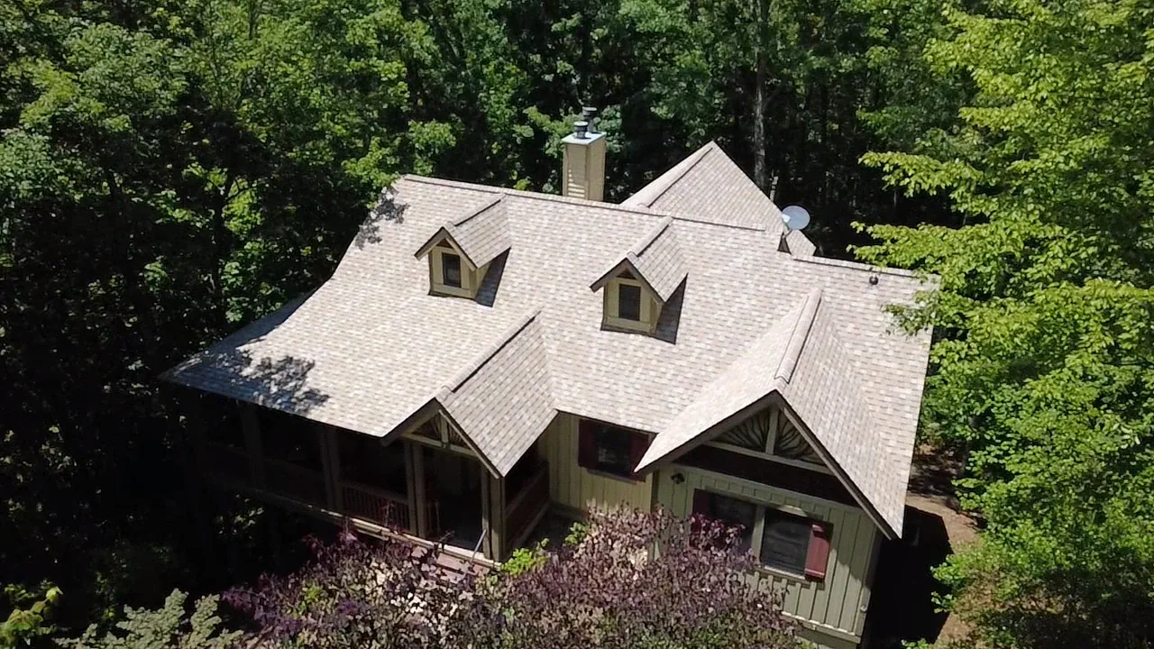 Dimensional shingle re-roof with dormers on a wooded Western North Carolina mountain home by Highlander Building Services